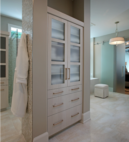 Custom built-in bathroom cabinet Sarasota featuring frosted glass upper doors and drawer storage by EuroTech Cabinetry