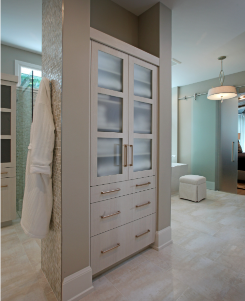 Custom built-in bathroom cabinet Sarasota featuring frosted glass upper doors and drawer storage by EuroTech Cabinetry