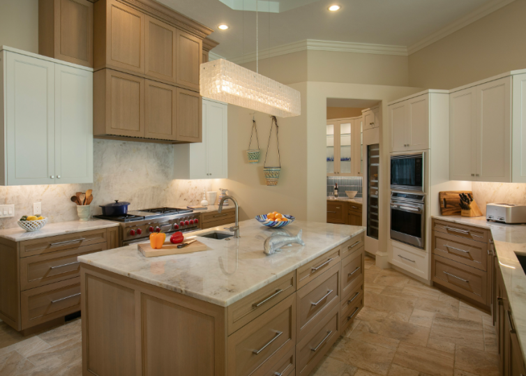 High-end kitchen cabinets Sarasota — two-tone transitional kitchen featuring natural wood lower cabinets and white upper cabinetry with marble countertops by EuroTech Cabinetry